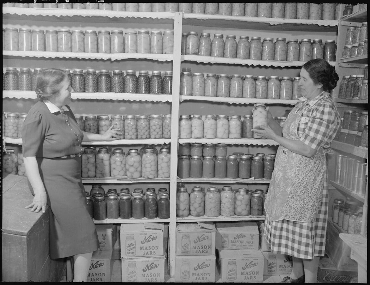 A 1940s pantry with shelves of home-canned jars floor to ceiling